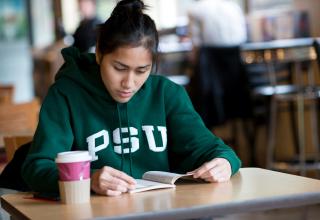 girl in PSU sweatshirt reading