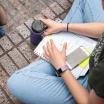 notebook and phone in lap