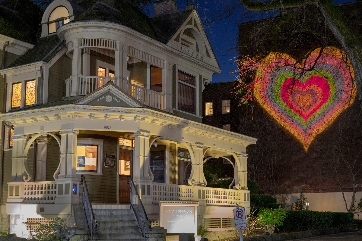 Simon Benson House with Heart light display projected on building in background