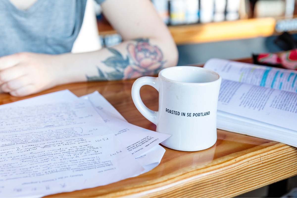 Coffee cup on table with study papers on table