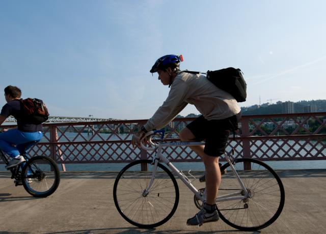 Person biking on a Portland bridge