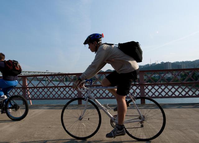 Person biking on a Portland bridge