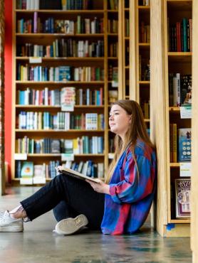 Photo of person sitting with a book