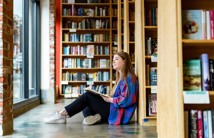 Photo of person sitting with a book