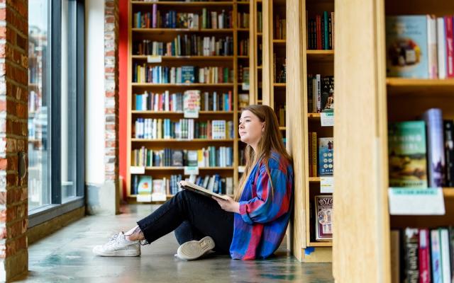 Photo of person sitting with a book