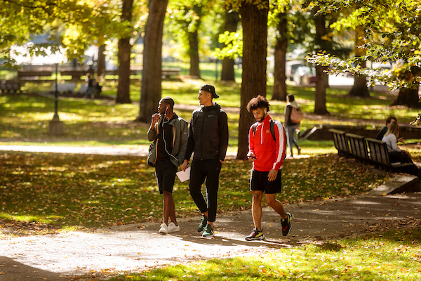 3 students walking. 