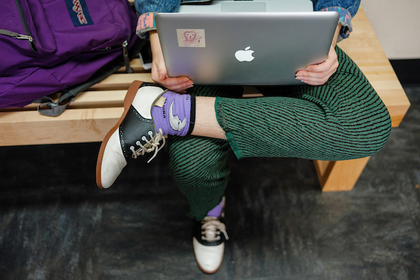 Student sitting with laptop.