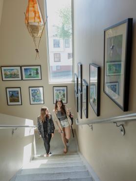 Two students walking up stairs