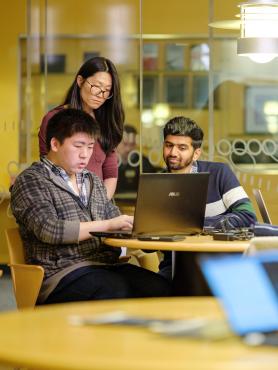 Students looking at laptop