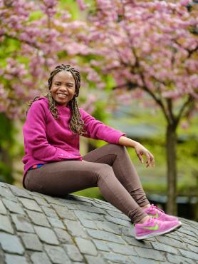 Student sitting on rock 