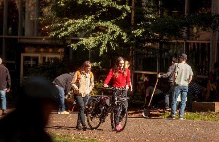 Students pushing bicycle