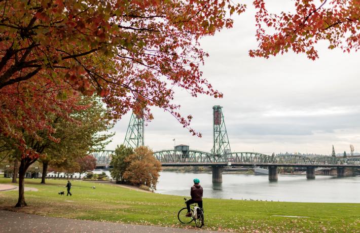 Student on bicycle by Steel Bridge