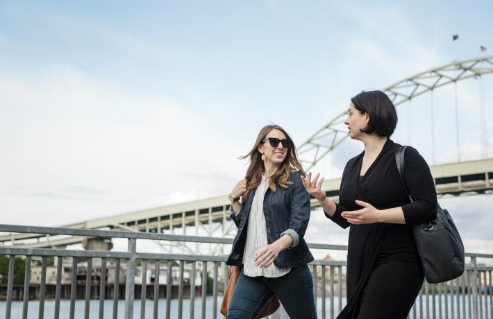 Students in Suit Jackets, walking along river
