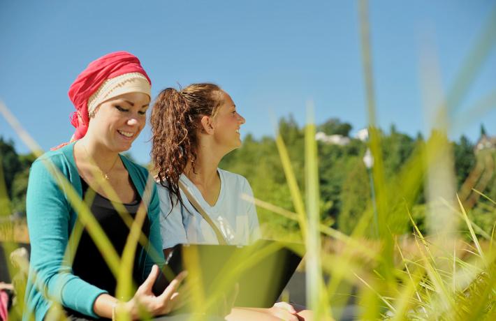 Two students together outside