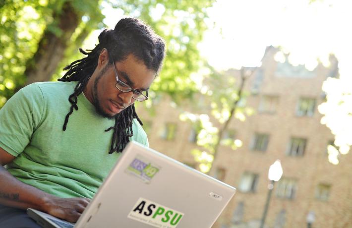Student on laptop outside