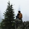 Man sitting on rock during hike