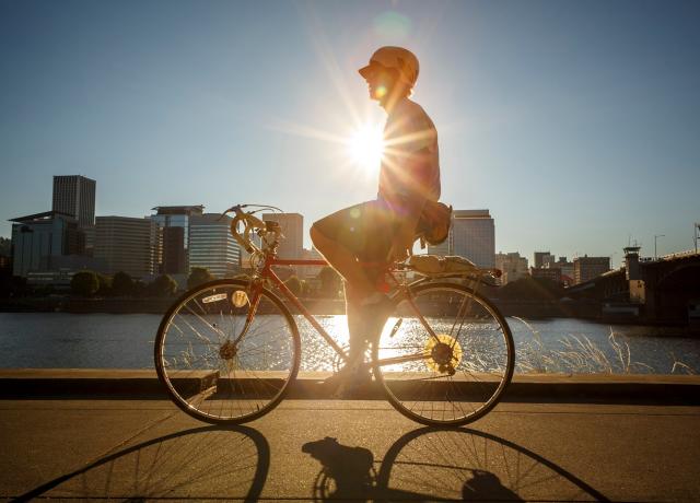 image of a student on a bike