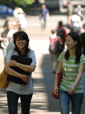 Two students walking in the park blocks