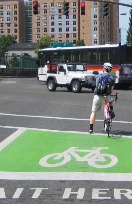 Riders in a green bike box at an intersection