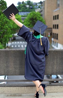 a newly graduated student showing their diploma