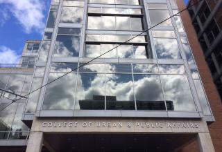 CUPA building with clouds reflected in window