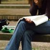 Woman studying on a bench