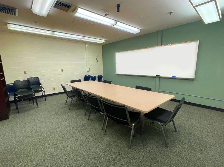 Conference table with chairs and large white board