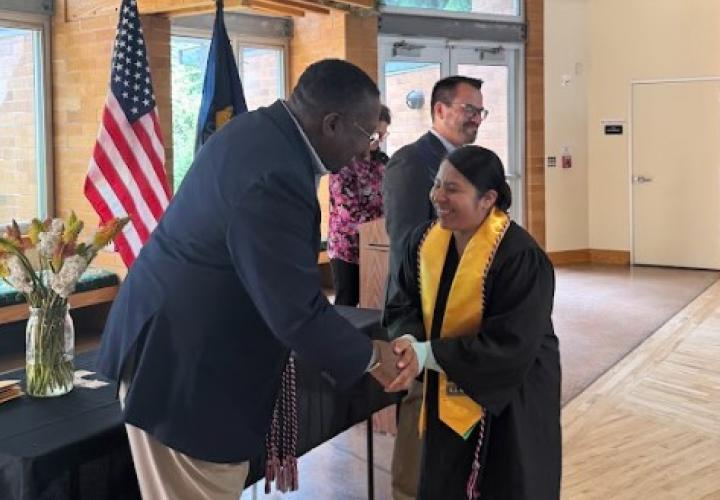 Student receiving veteran graduation cord.