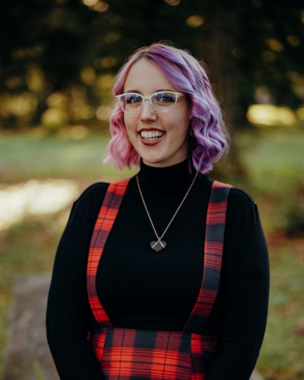 grad student with glasses and necklace