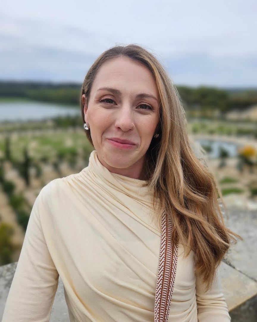 graduate student outside with landscape in background