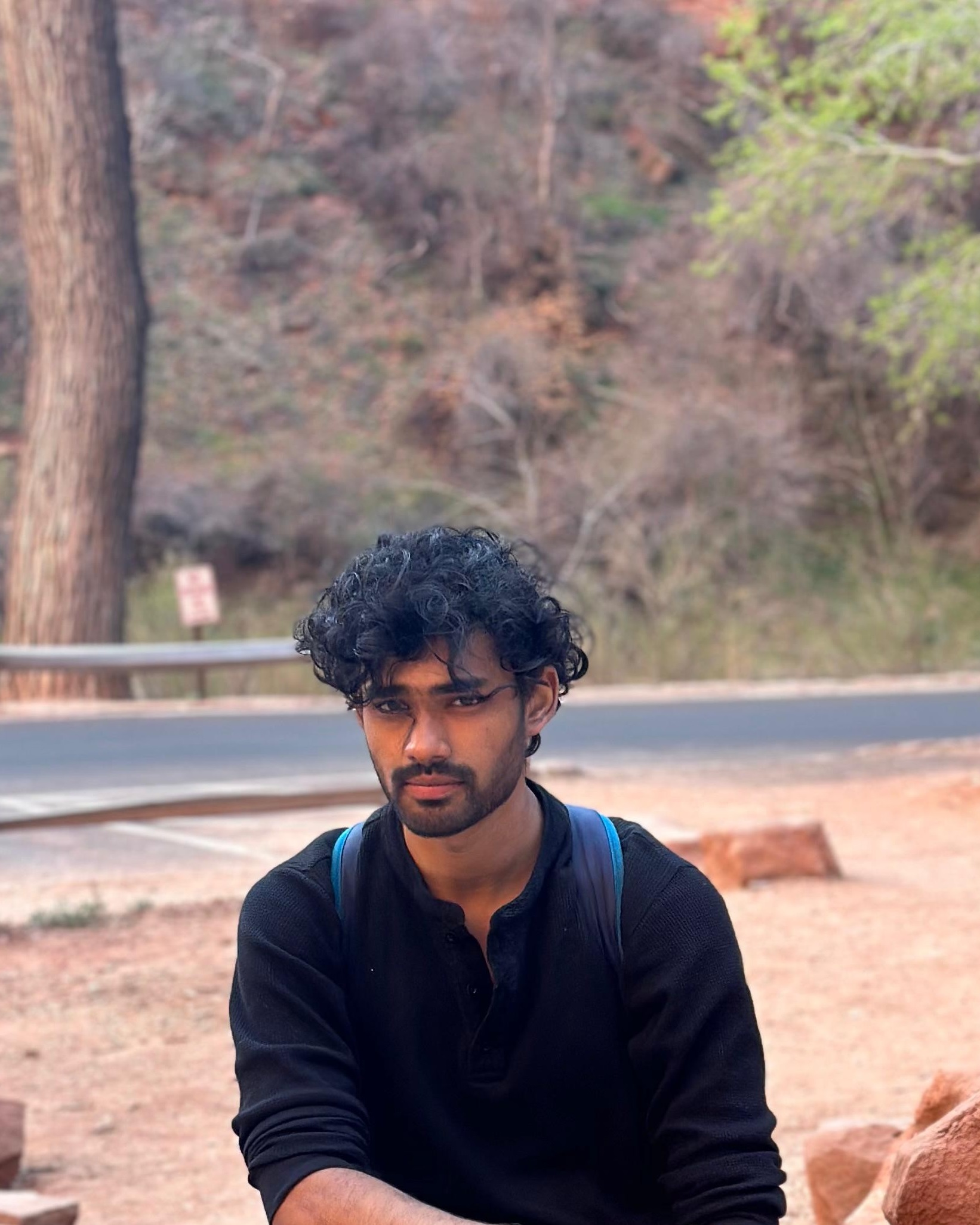 graduate student sitting outside at campground