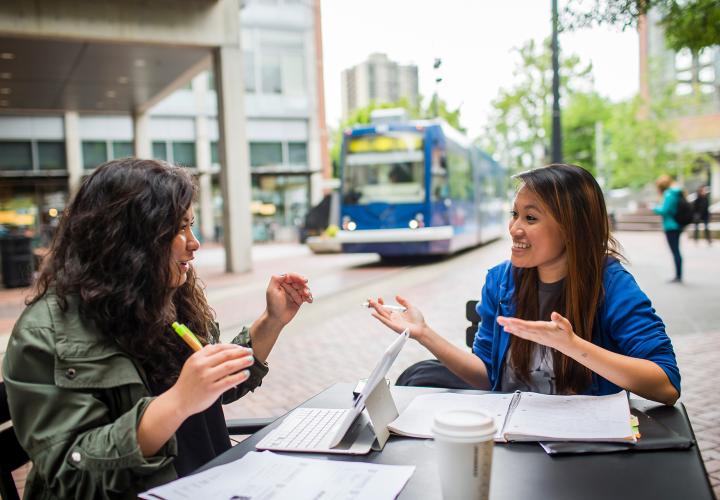 Students studying and laughing in Urban Plaza