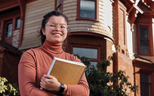 Honors student in front of the Honors House