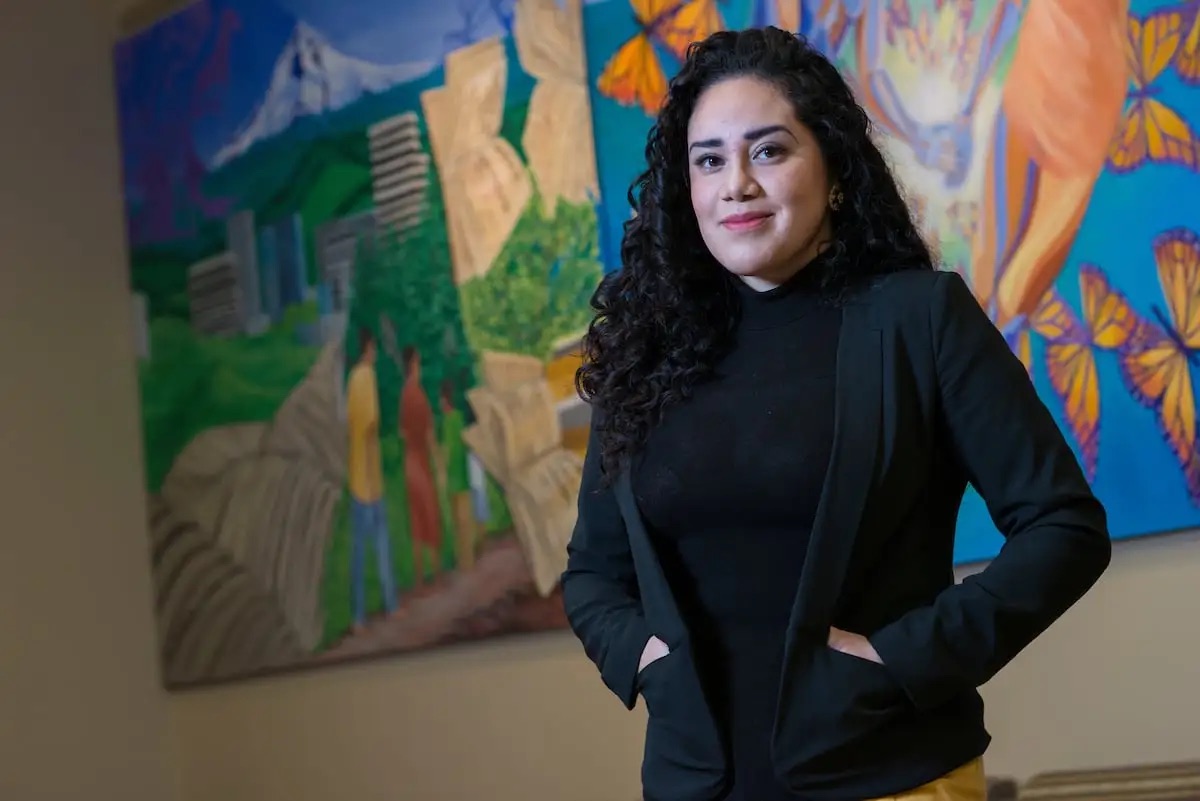 Student in front of mural