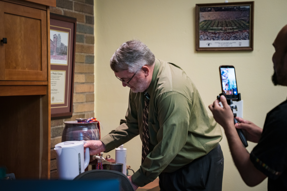 Dean Bowman brewing his morning coffee in his office