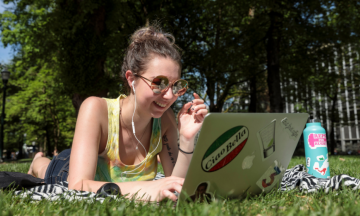 student looking at laptop on south park blocks