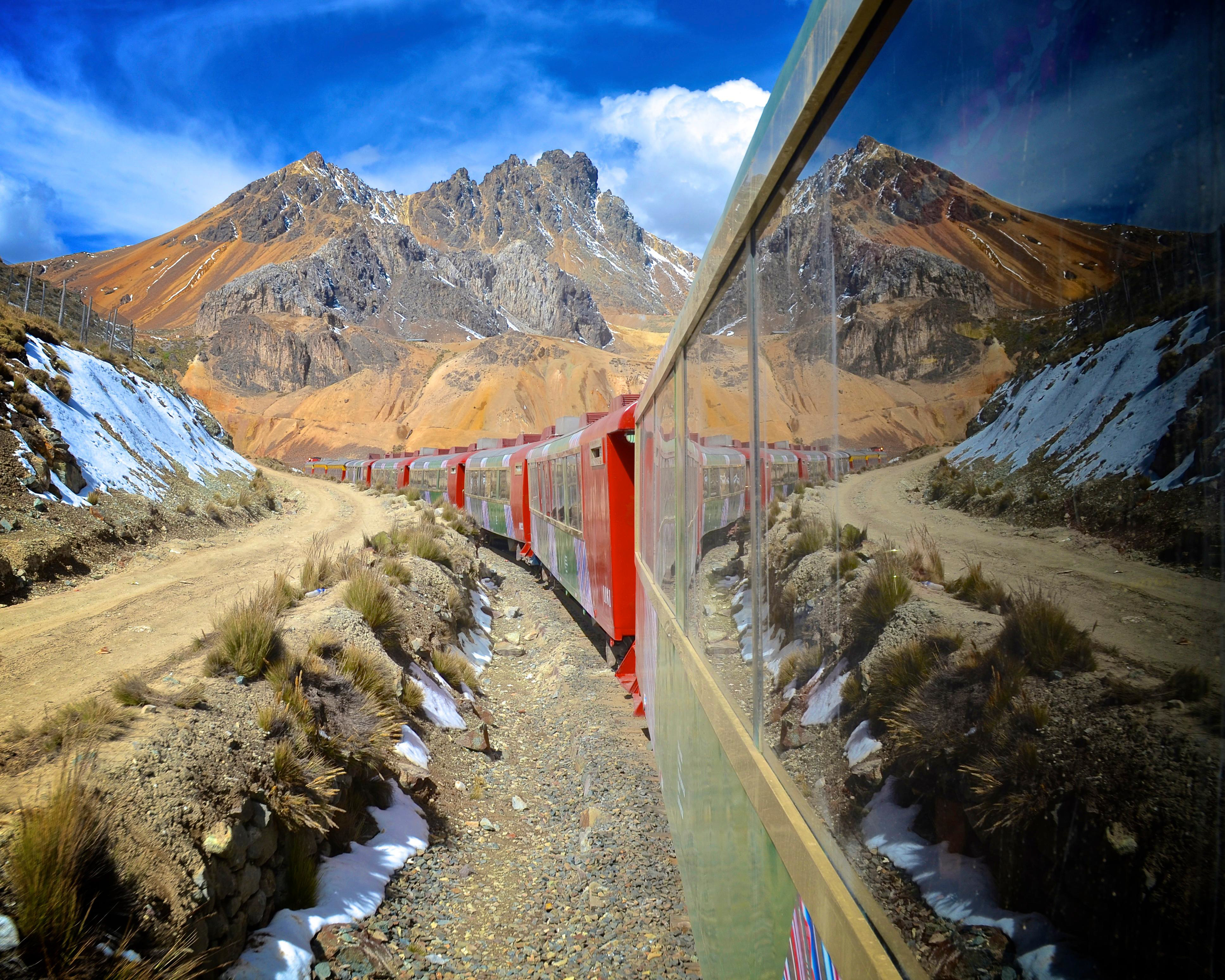 A picture of a train crossing through mountains