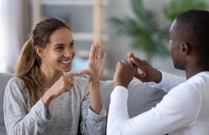 Two people communicating in sign language