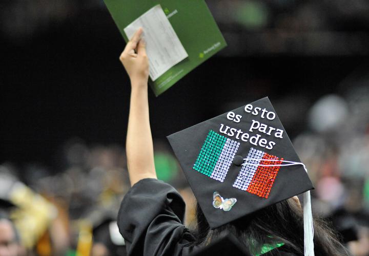 Back of student in cap and gown waving