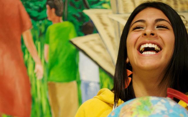 PSU world languages student holding a globe